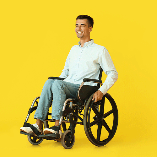 Smiling man in a wheelchair against a bright background, symbolising independence and continence support services in East Brisbane.