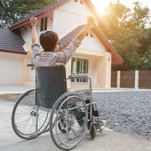 Person using a wheelchair celebrating independence outside a home, representing disability and continence support services in Nollamara, Western Australia 6061.