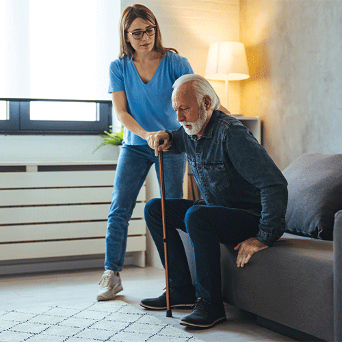 Support worker discussing care documents with a woman in a wheelchair, representing continence assessment and disability support in Canberra, ACT.