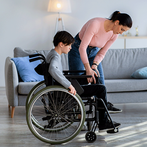 Carer supporting an elderly man to stand safely at home, representing continence care and daily living support services in Liverpool, NSW.