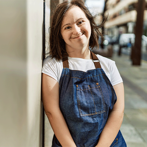 Woman with disability smiling outdoors, representing inclusive continence assessment and NDIS support services in Bellerive, Tasmania.