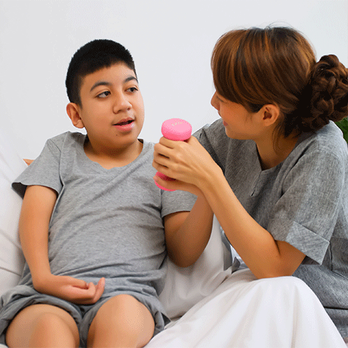 Support worker engaging with a child at home, representing personalised continence assessment and disability support services in Hobart, Tasmania.