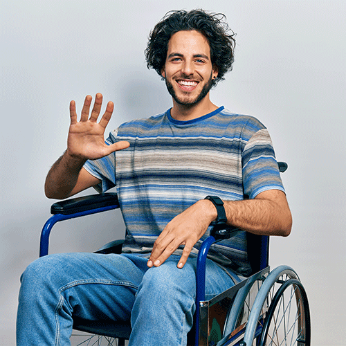 Young man in a wheelchair smiling and waving — continence assessment in Toowoomba by A1 Care Group