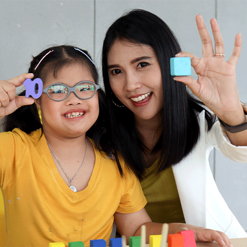 NDIS support worker and young girl with disability smiling during continence assessment support session in Eltham, VIC