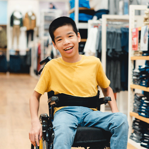 Young NDIS participant in a wheelchair smiling — continence assessment services in Werribee VIC by A1 Care Group