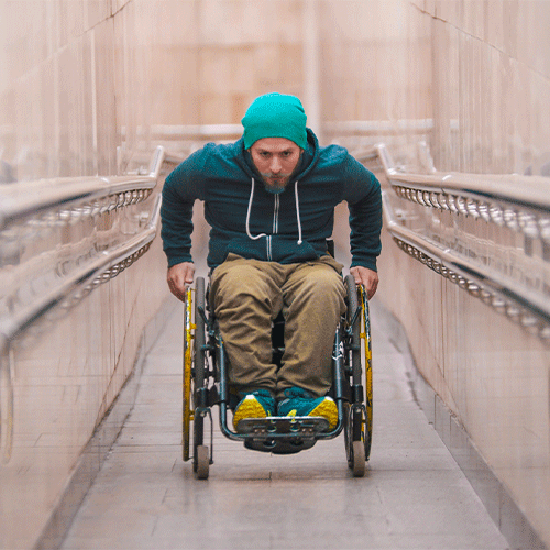 NDIS participant using a wheelchair on an accessible ramp, supported by a continence assessment in Macquarie Fields, NSW